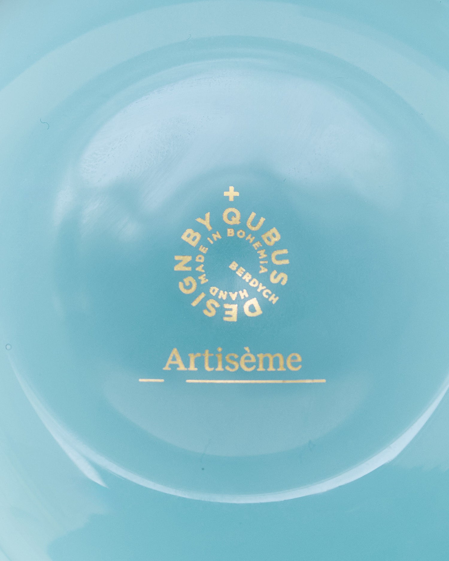 Detail of the turquoise Unnamed Baby vase by Artisème, featuring elegant gold text.